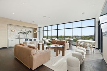 Houston apartment for rent - A living room with a large couch and a dining table.