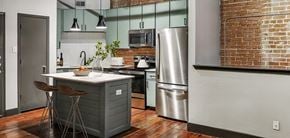 Houston apartment for rent - Houston apartment kitchen with sage cabinets and stainless steel appliances