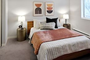 Bensenville apartment for rent - made bed with two nightstands and wall art