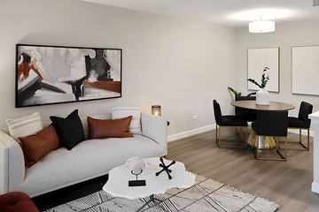 Bensenville apartment for rent - A living room with a white couch, a coffee table, and a painting on the wall.