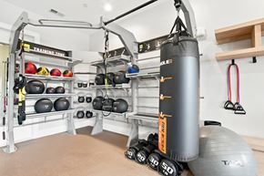 St. Charles apartment for rent - A gym with a punching bag, weights and a bench.