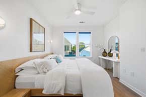 Spring townhouse for rent - bedroom with a large bed and a view of the outside.