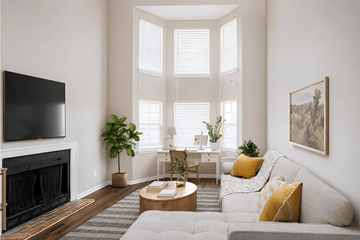 Gallatin apartment for rent - A living room with a grey couch, a fireplace, and a painting on the wall.