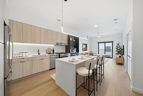 Houston apartment for rent - A modern kitchen with a dining table and chairs.