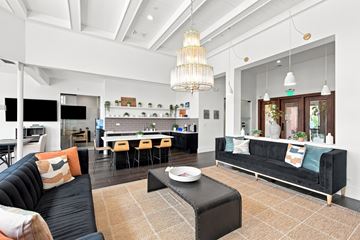 St. Charles apartment for rent - A living room with a black couch and a coffee table.