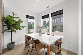 Spring townhouse for rent - A dining room with a white table and chairs.