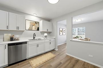 Arlington Heights apartment for rent - A kitchen with white cabinets and a wooden floor.