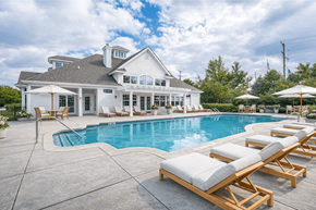 Aurora apartment for rent - A large house with a pool and lounge chairs.