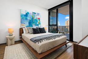Chicago apartment for rent - A bedroom with a large bed and a painting on the wall.