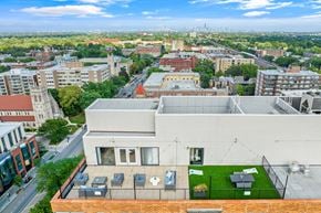 Oak Park apartment for rent - an aerial view of a building with a green roof and the philadelphia skyline in the background