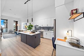 Houston apartment for rent - A modern kitchen with a dining table and chairs.