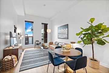Houston apartment for rent - A living room with a dining table and chairs.