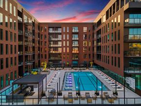 Houston apartment for rent - A large indoor swimming pool surrounded by brick buildings.