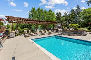 Ann Arbor apartment for rent - A swimming pool with a wooden pergola over it.