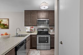 Ann Arbor apartment for rent - A modern kitchen with a stainless steel oven and microwave.