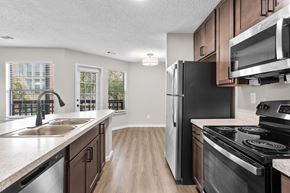 Southfield apartment for rent - A kitchen with a black refrigerator and stove.
