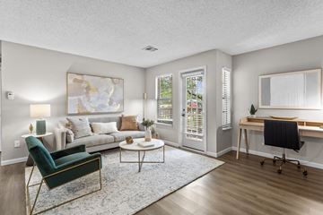 Southfield apartment for rent - A living room with a green chair and a white couch.