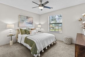Southfield apartment for rent - A bedroom with a large bed and a ceiling fan.
