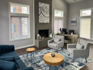 Columbus apartment for rent - a living room with a blue couch and chairs and a rug