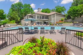 Antioch apartment for rent - sundeck with lounge chairs by the pool with The Magnolia apartment building in the background