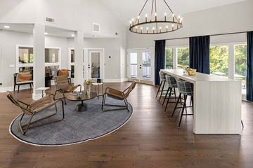 Antioch apartment for rent - A modern living room with a large rug and a chandelier.