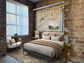 Villa Park townhouse for rent - A bedroom with a brick wall and a bed with a brown headboard.