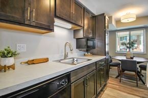Romulus apartment for rent - renovated kitchen with brown cabinets