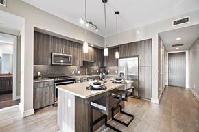Houston apartment for rent - a kitchen with a large island with a table and chairs