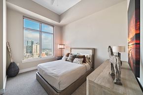 Houston apartment for rent - a bedroom with a bed and a view of the city