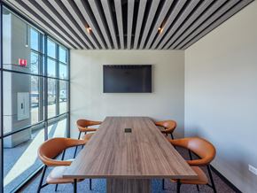 Chicago apartment for rent - a conference room with a wooden table and chairs and a television