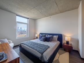 Chicago apartment for rent - a bedroom with a bed and a large window