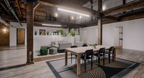 Houston apartment for rent - A modern dining area with a wooden table and chairs.