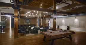 Houston apartment for rent - A pool table is in the middle of a room with a couch and chairs.