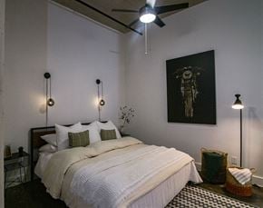 Houston apartment for rent - A bedroom with a large bed and a ceiling fan.