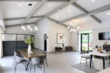 Romulus apartment for rent - a living room and dining room with a table and chairs