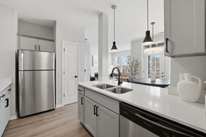 Aurora apartment for rent - A modern kitchen with a stainless steel refrigerator and a white countertop.