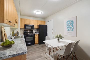 Chicago apartment for rent - A kitchen with a table and chairs in front of it.