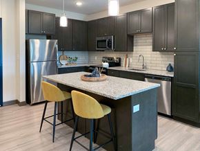 Lincoln townhouse for rent - a kitchen with stainless steel appliances, granite counter tops, and an island