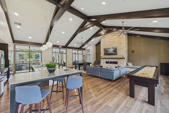 Party room with a pool table, shuffleboard and more