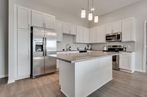 Woodbury townhouse for rent - Luxury kitchen with white cabinets and an island at Aspire at CityPlace in Woodbury MN 55125