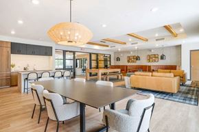 Lincoln apartment for rent - A clubroom with a dining area next to a kitchenette and lounge area that residents can rent out for private events.