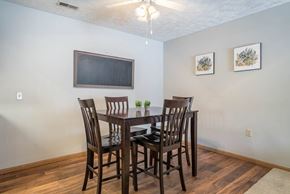Omaha apartment for rent - A dining room with a wooden table and chairs.