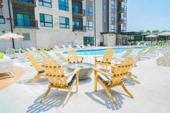 Fire pit surrounded by adirondack chairs