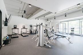 Lincoln apartment for rent - a gym with various exercise equipment in a room with windows