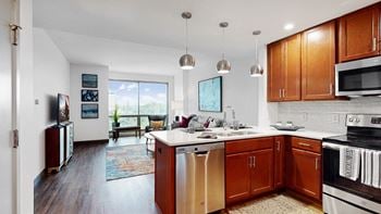 Kitchen and living area of a midtown crossing apartments omaha 1 bedroom apartment