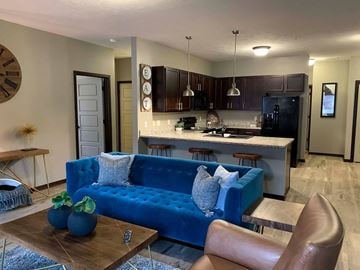 Lincoln townhouse for rent - a blue couch in a living room next to a kitchen