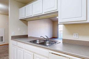 Lincoln apartment for rent - A kitchen with white cabinets and a stainless steel sink.