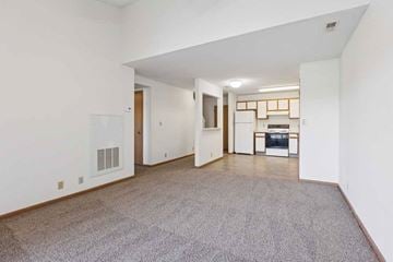 Lincoln apartment for rent - A spacious living room with a grey carpet and white walls.