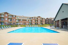Lincoln apartment for rent - Poolside view with an apartment building in the background