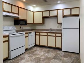 Lincoln apartment for rent - a kitchen with white appliances and white and wooden cabinets